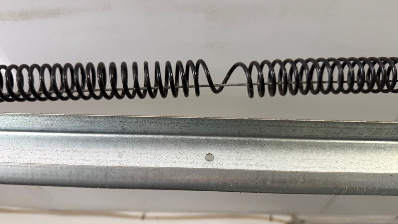 Cliffside Park NJ garage door extension spring close-up during repair inspection