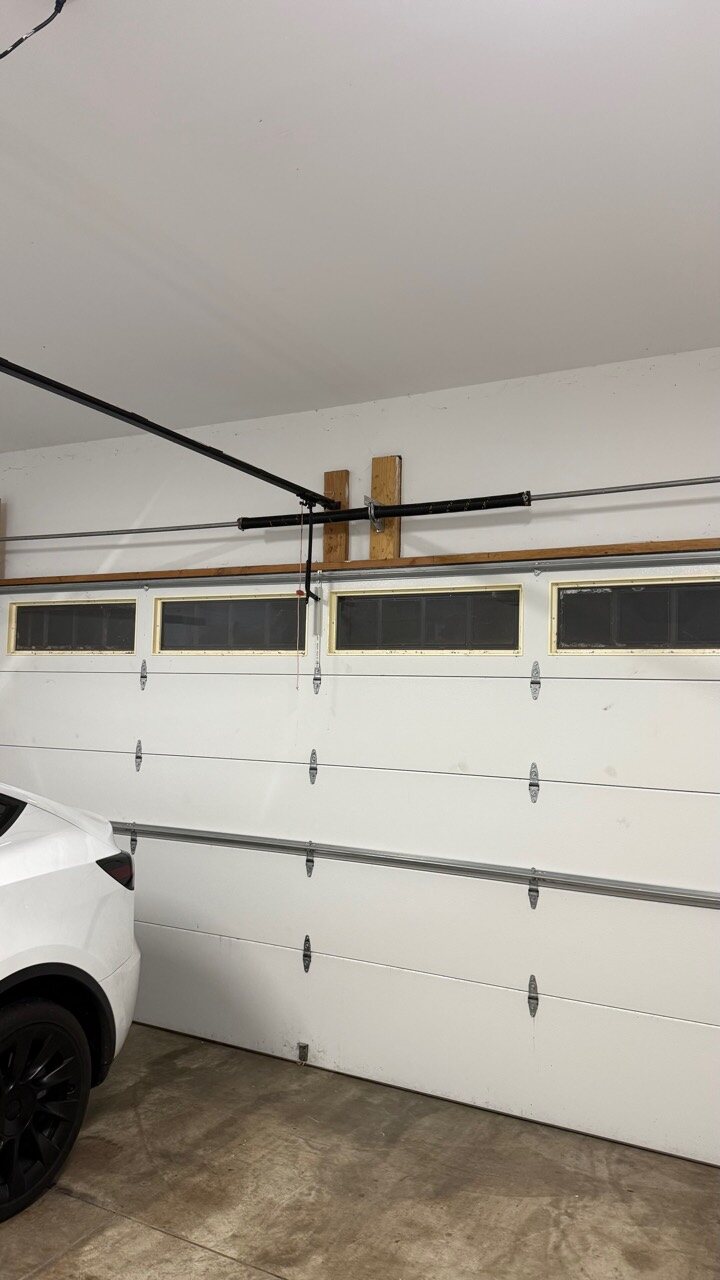 Cresskill NJ garage door torsion spring system above a residential sectional door