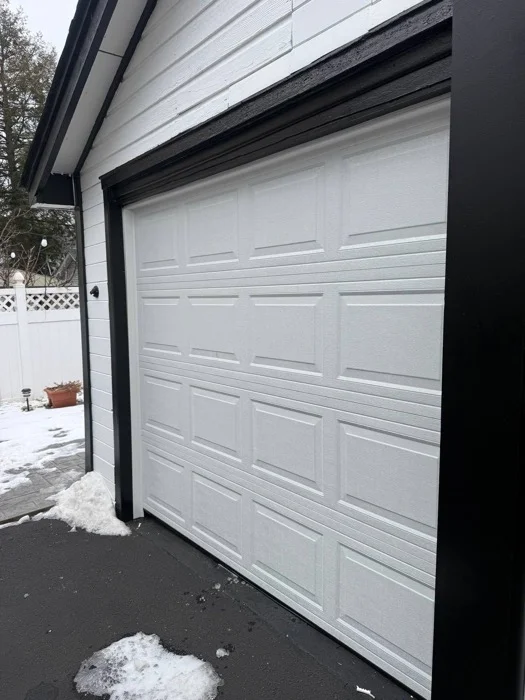 Completed single garage door installation in winter