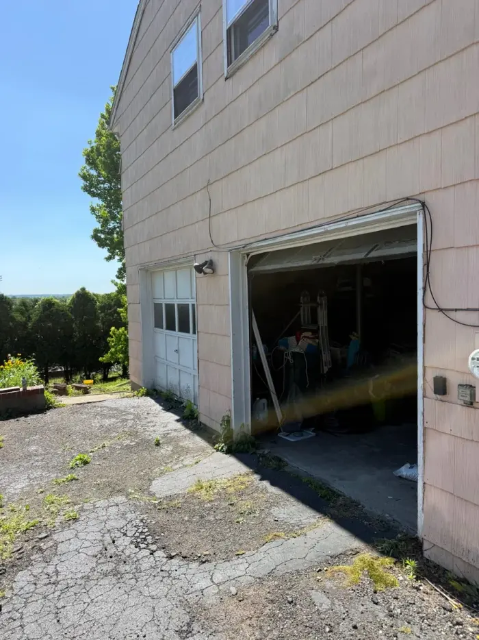Garage door service visit in Paramus NJ with tools near the door track