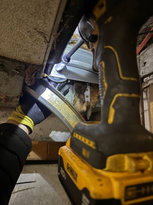 Garage door roller and track repair closeup with DeWalt tools