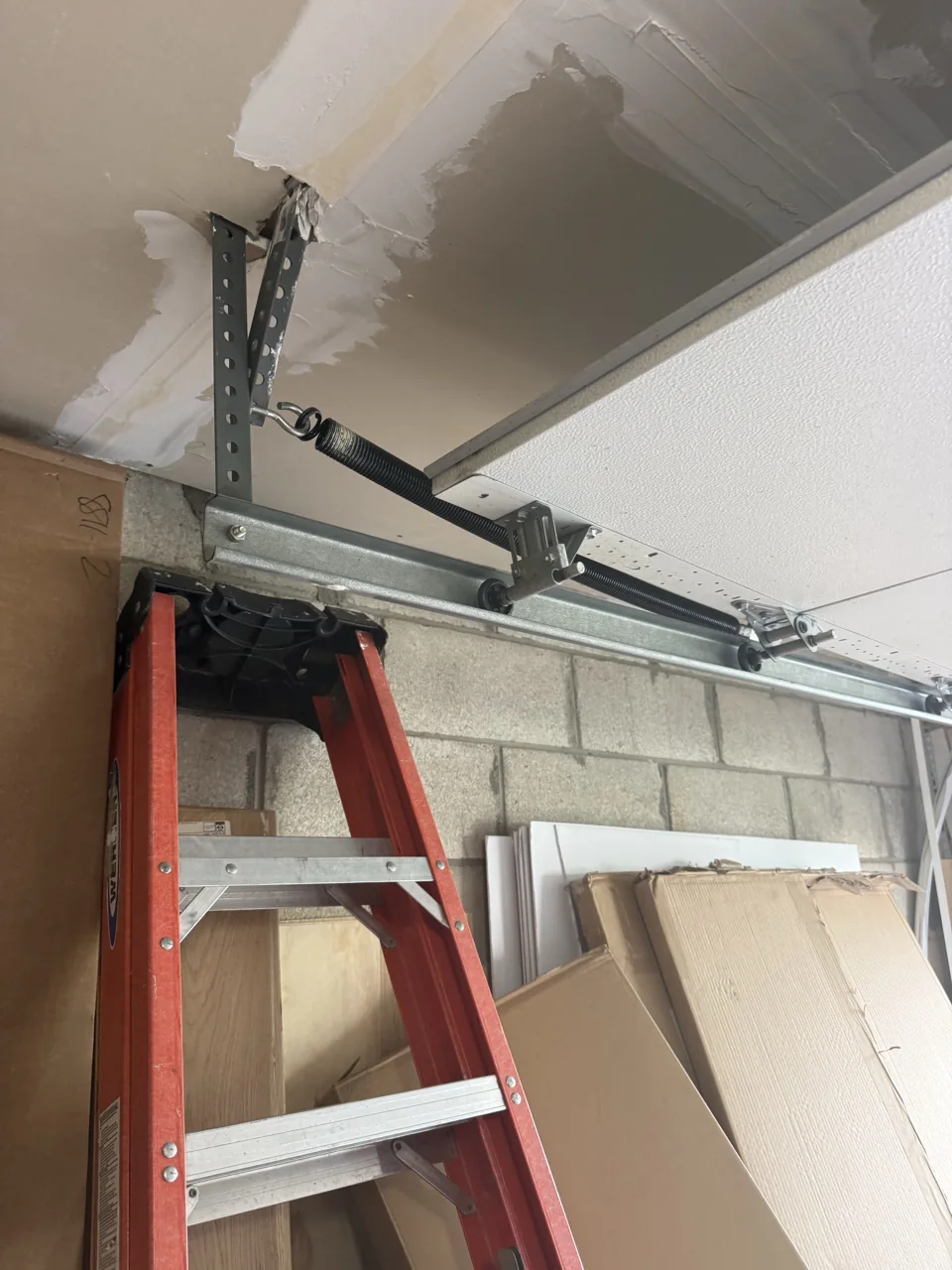 Extension spring alongside the garage door track during our West Orange repair visit