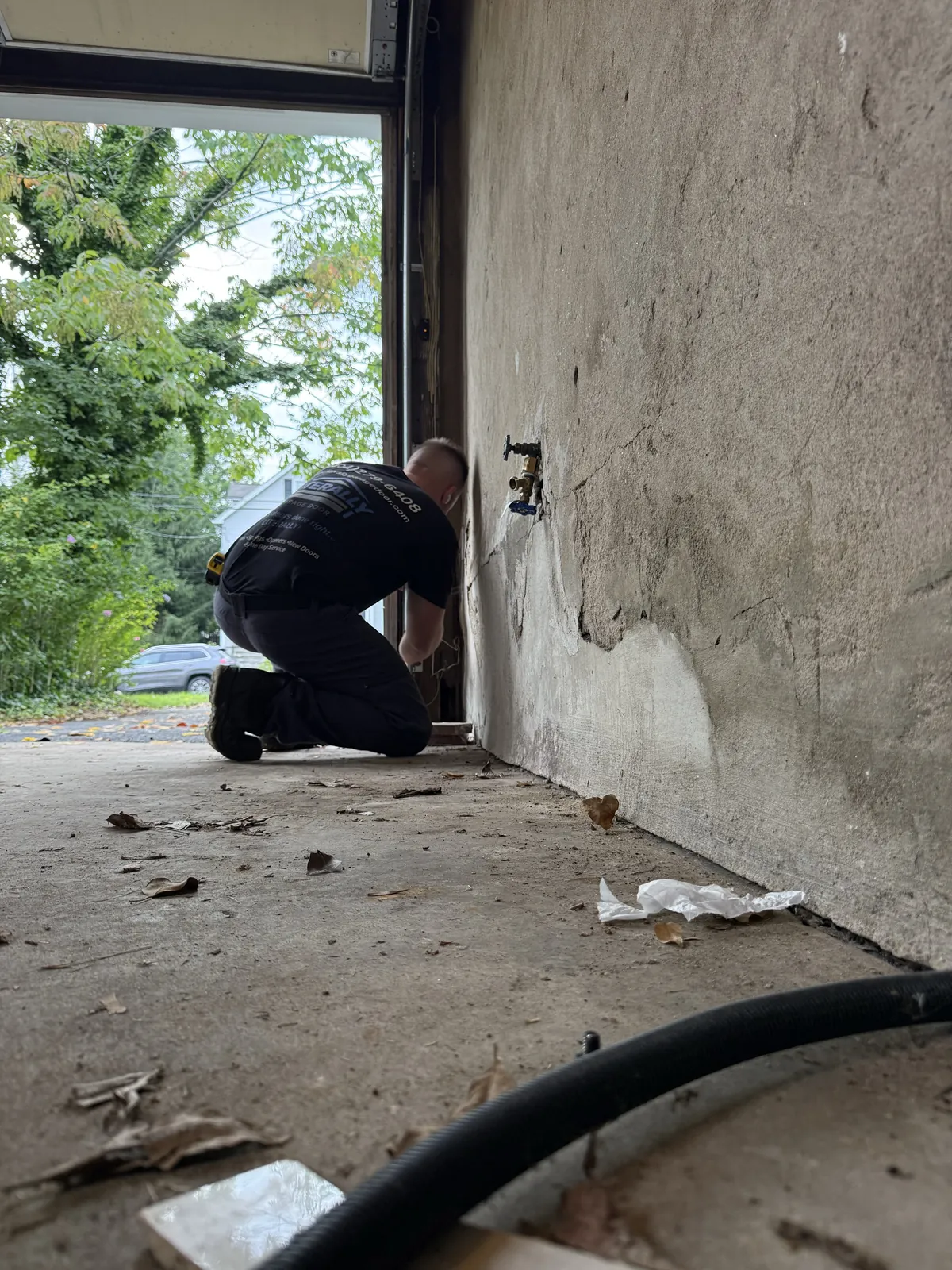 Literally Garage Door technician replacing a garage door safety sensor in Millburn, NJ
