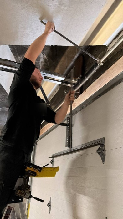 Roni Drutski, owner of Literally Garage Door, installing a garage door opener