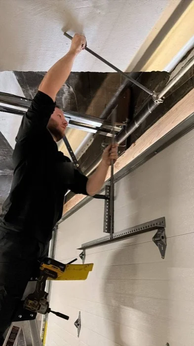 Roni Drutski working on garage door opener installation in Northern NJ